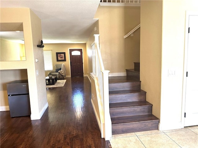 staircase with hardwood / wood-style floors