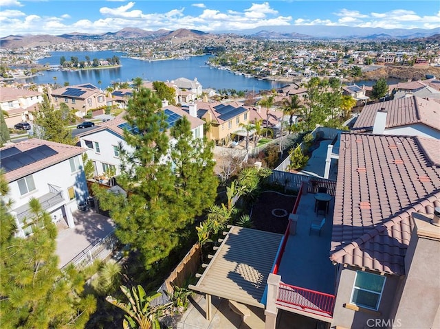 drone / aerial view featuring a water and mountain view