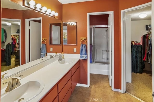 bathroom featuring a textured ceiling and vanity