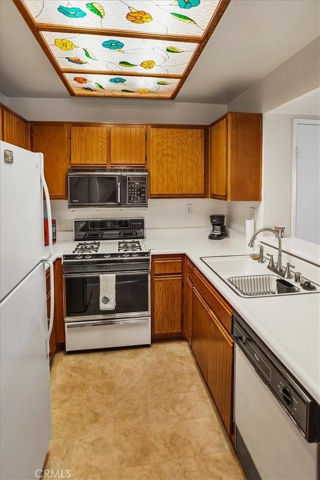 kitchen featuring sink and white appliances