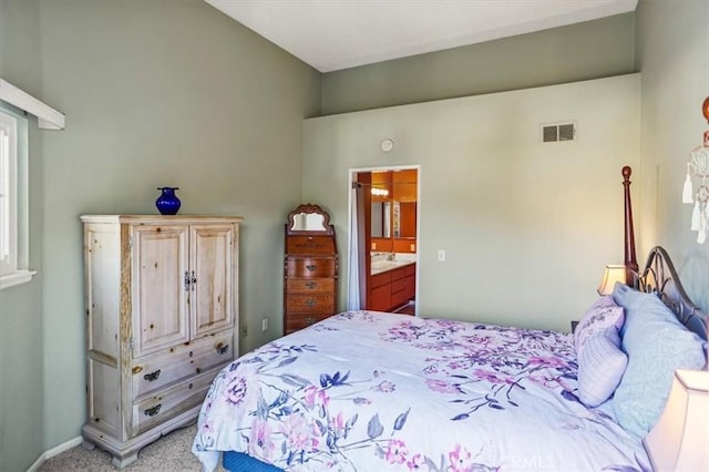 carpeted bedroom featuring connected bathroom