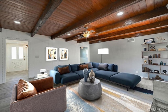 living room featuring ceiling fan, wooden ceiling, hardwood / wood-style flooring, and beamed ceiling