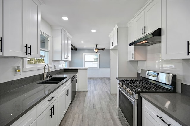 kitchen with sink, white cabinets, black dishwasher, and stainless steel gas range oven