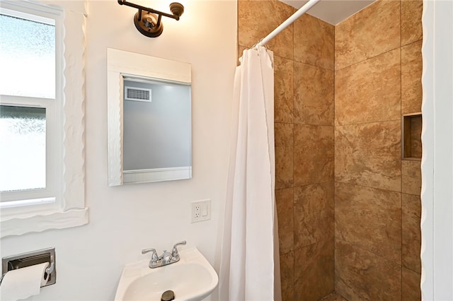 bathroom featuring sink and a shower with shower curtain