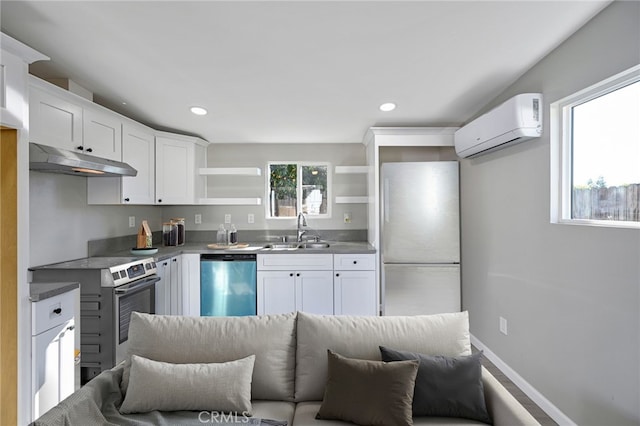 kitchen featuring appliances with stainless steel finishes, sink, white cabinetry, and a wall mounted air conditioner