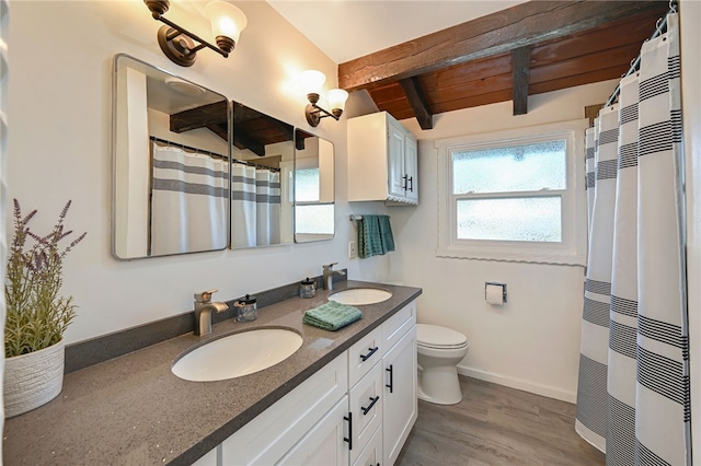 bathroom featuring hardwood / wood-style floors, vanity, a shower with curtain, toilet, and beam ceiling