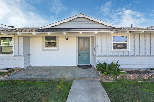 property entrance with a yard