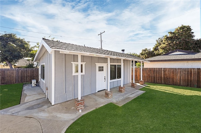 rear view of house with a yard