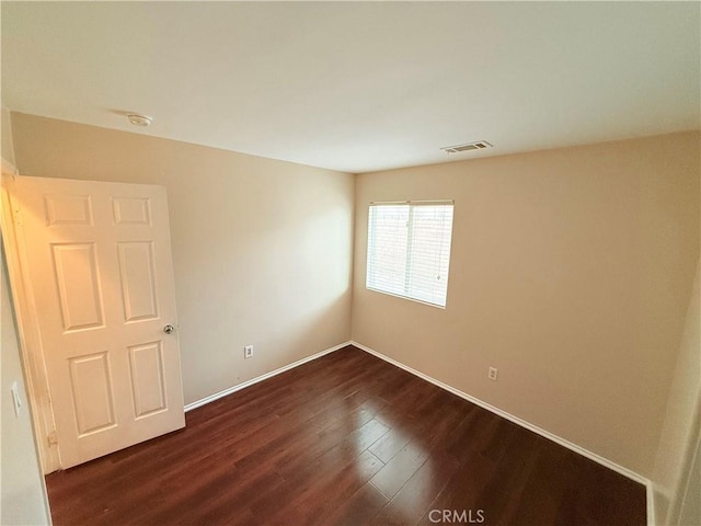 empty room with dark wood-type flooring