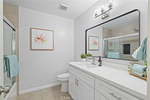 full bathroom featuring vanity, tile patterned flooring, combined bath / shower with glass door, and toilet