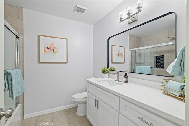 full bath with toilet, vanity, baseboards, visible vents, and shower / bath combination with glass door