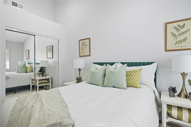 bedroom with visible vents and a closet