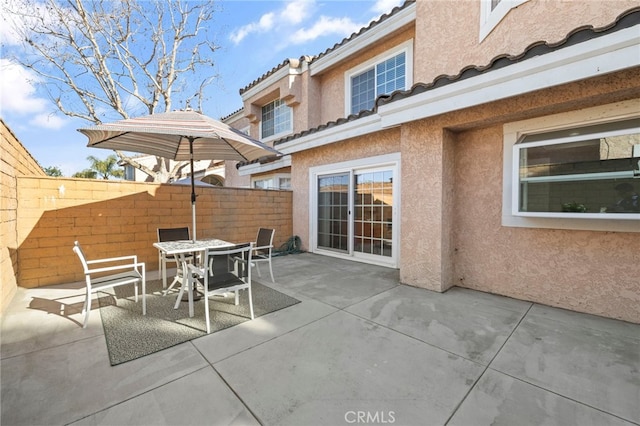 view of patio with fence and outdoor dining area