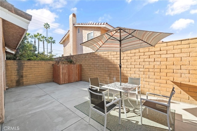 view of patio / terrace featuring fence and outdoor dining area