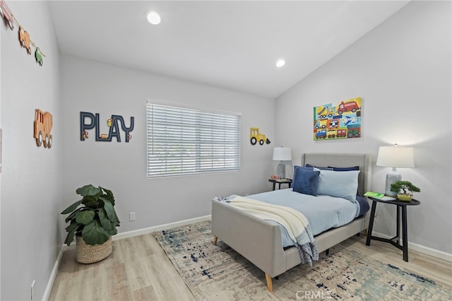 bedroom with wood-type flooring and vaulted ceiling