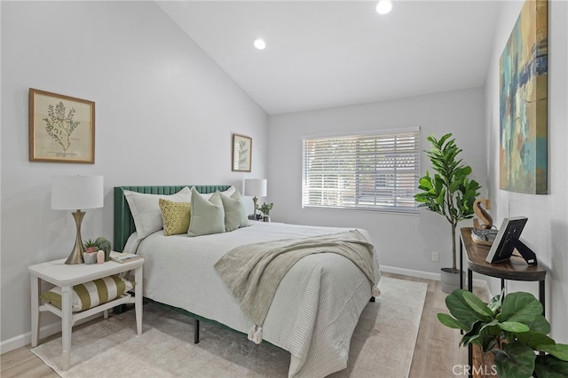 bedroom with recessed lighting, baseboards, lofted ceiling, and wood finished floors