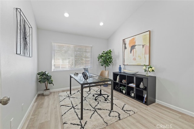 office with light hardwood / wood-style flooring and vaulted ceiling