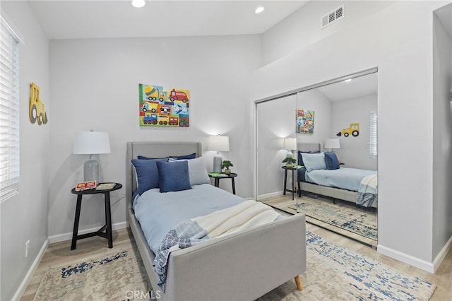 bedroom with light hardwood / wood-style flooring and a closet