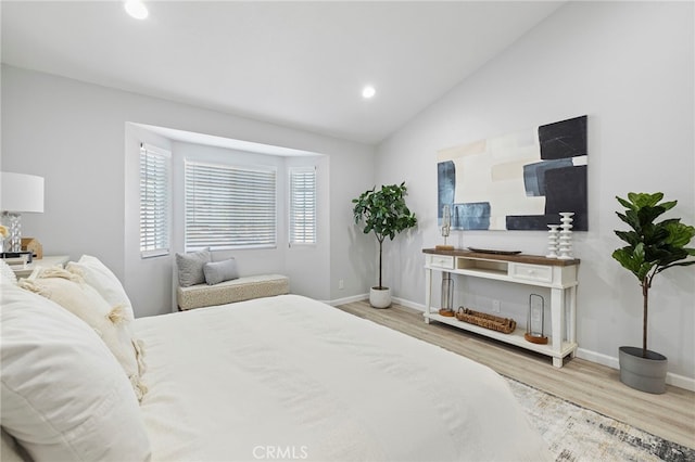 bedroom featuring vaulted ceiling and light wood-type flooring