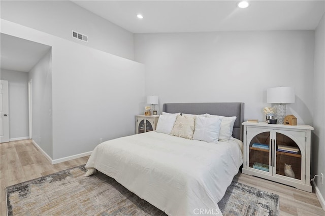 bedroom featuring wood finished floors, recessed lighting, baseboards, and visible vents