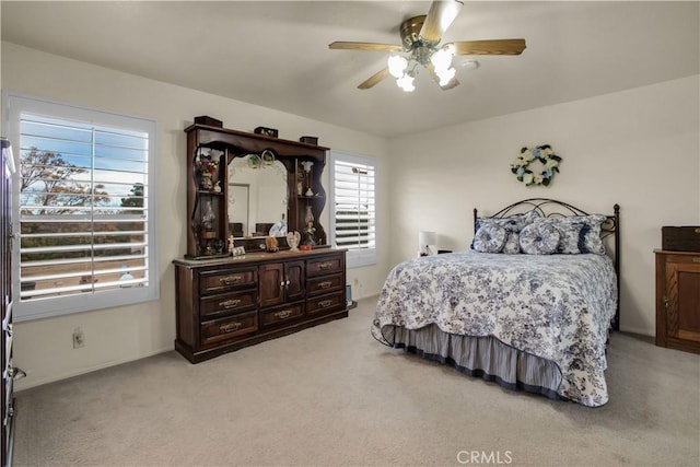 bedroom featuring ceiling fan and light carpet