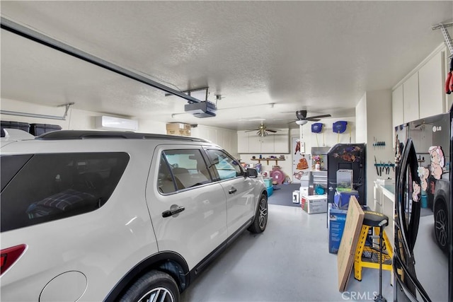 garage with ceiling fan, a garage door opener, and black refrigerator