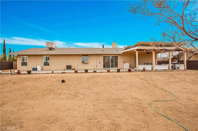 rear view of property featuring cooling unit, a patio area, and a gazebo