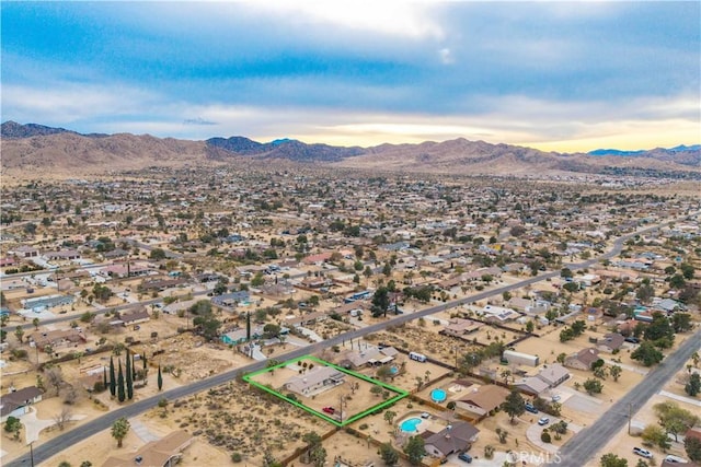 birds eye view of property featuring a mountain view