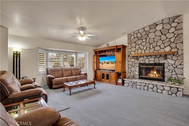 living room featuring ceiling fan, carpet, a fireplace, and lofted ceiling