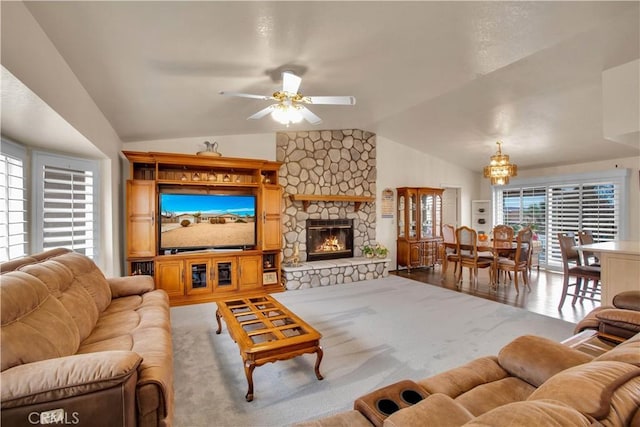 living room featuring ceiling fan, carpet, vaulted ceiling, and a fireplace