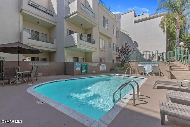 view of swimming pool featuring a patio