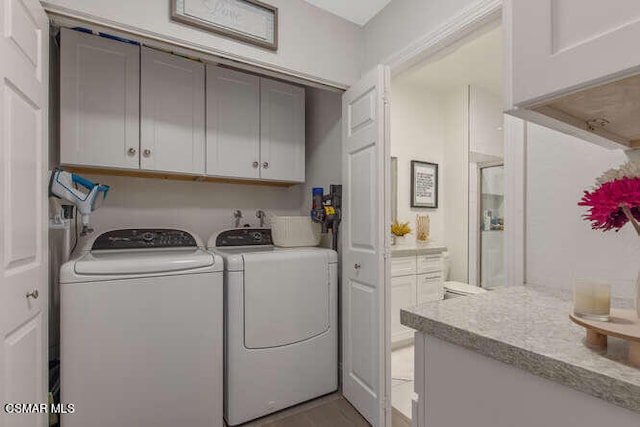 laundry area featuring cabinets and washing machine and clothes dryer