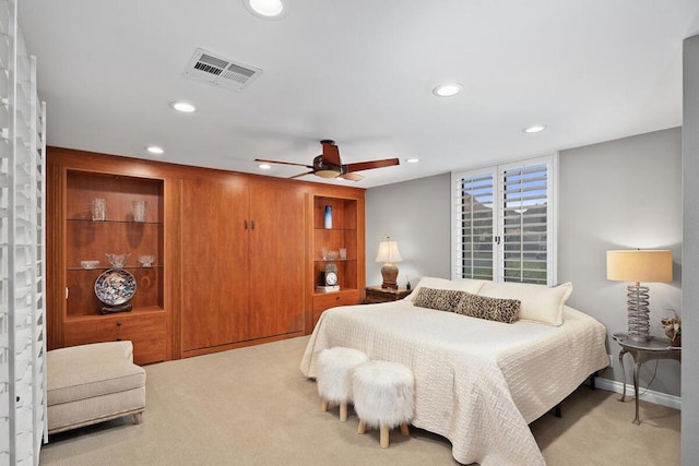 bedroom with ceiling fan and light colored carpet