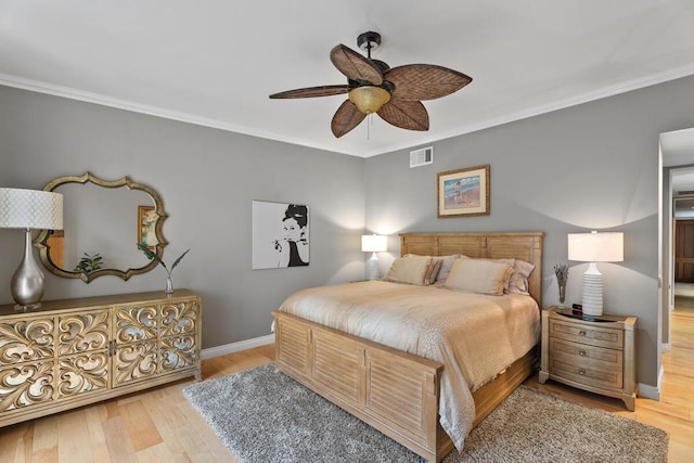 bedroom with ceiling fan, crown molding, and hardwood / wood-style floors