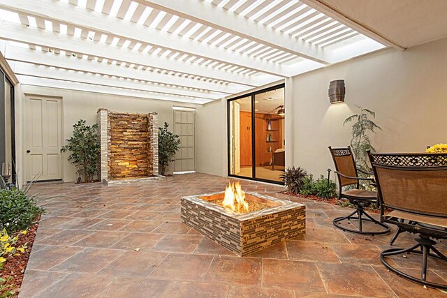 view of patio / terrace with a pergola and an outdoor fire pit