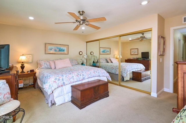 carpeted bedroom featuring a closet and ceiling fan