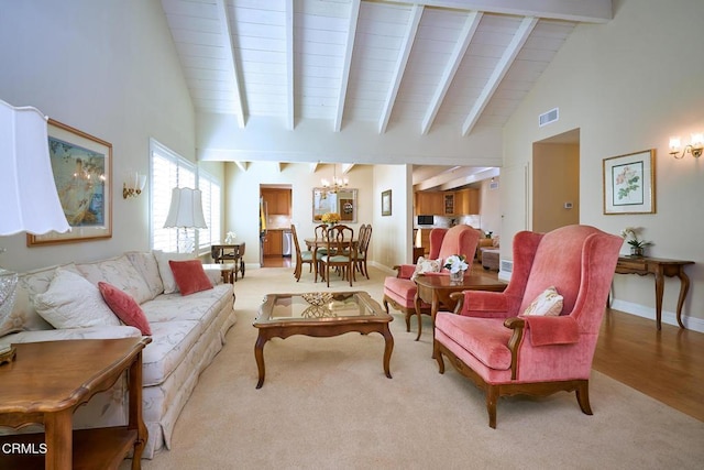 living room featuring light colored carpet, beam ceiling, and a notable chandelier