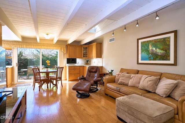 living room featuring wooden ceiling, beam ceiling, light hardwood / wood-style floors, and rail lighting