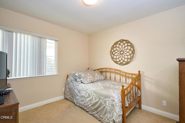 bedroom featuring light carpet