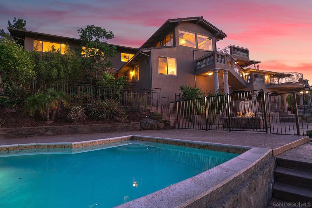 pool at dusk featuring a patio area