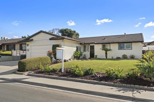 single story home with a garage and a front yard