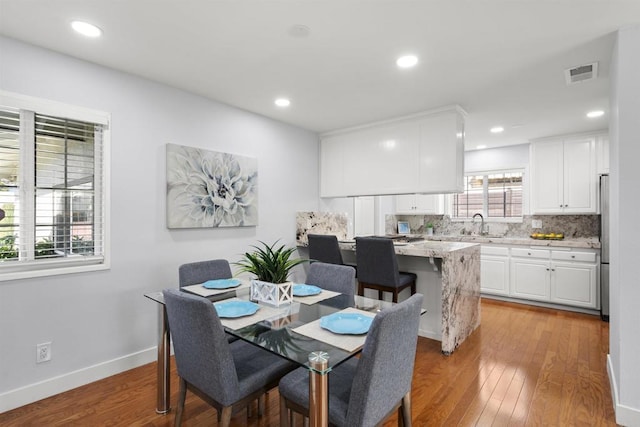 dining space featuring light hardwood / wood-style flooring and sink