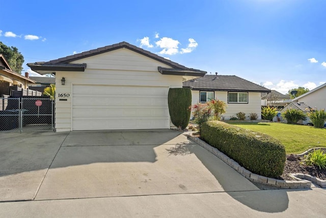 ranch-style home featuring a garage and a front yard