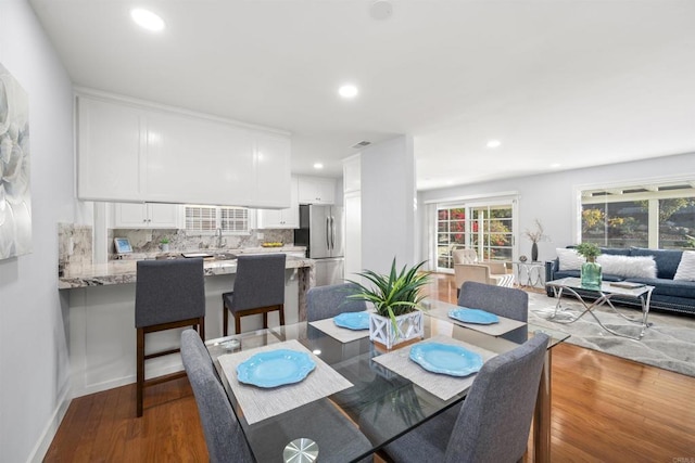 dining area with hardwood / wood-style floors and sink