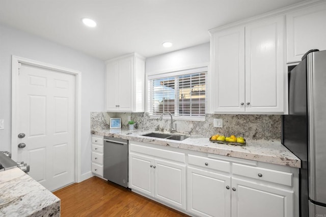 kitchen featuring sink, stainless steel appliances, and white cabinetry