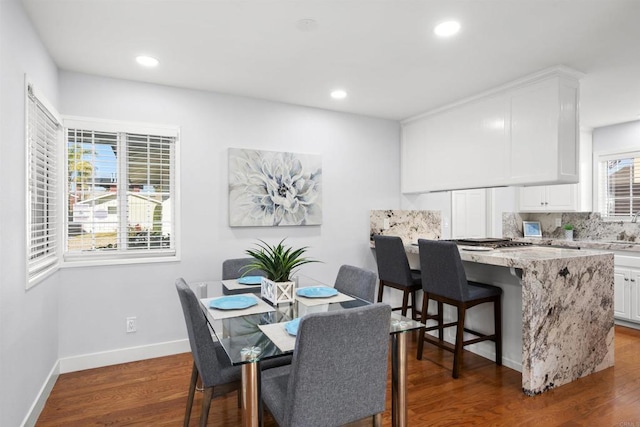 dining room featuring hardwood / wood-style flooring and sink