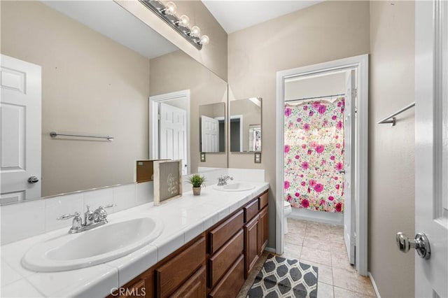 bathroom featuring tile patterned floors, toilet, vanity, and a shower with curtain