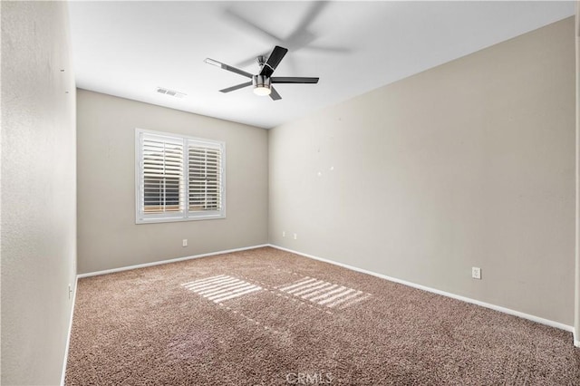 empty room with ceiling fan and carpet floors