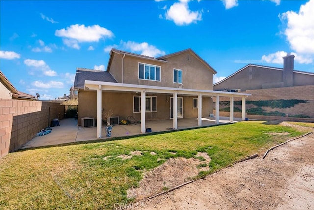 back of house featuring central AC, a patio area, and a yard