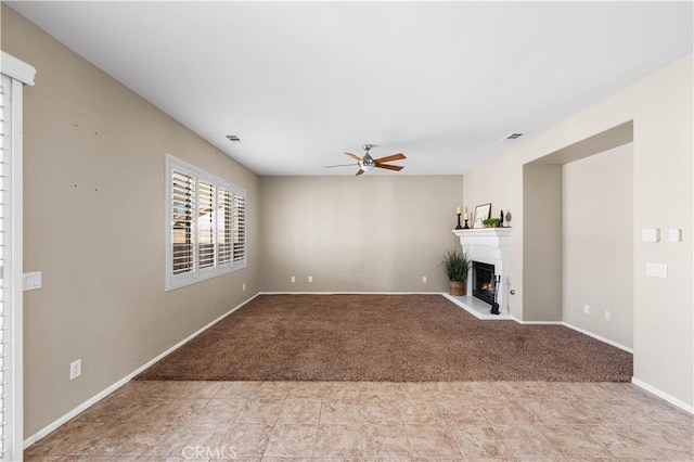 unfurnished living room featuring ceiling fan and light colored carpet